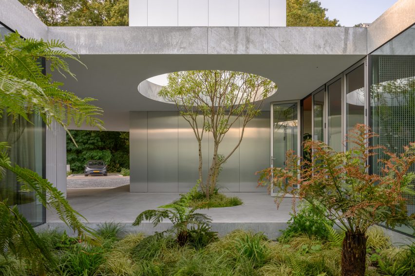 A courtyard lined with concrete and polished metal 