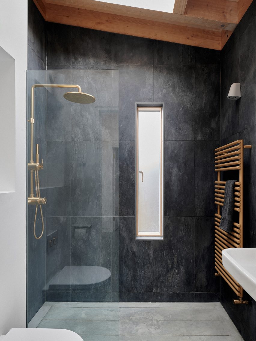A black-tiled shower room