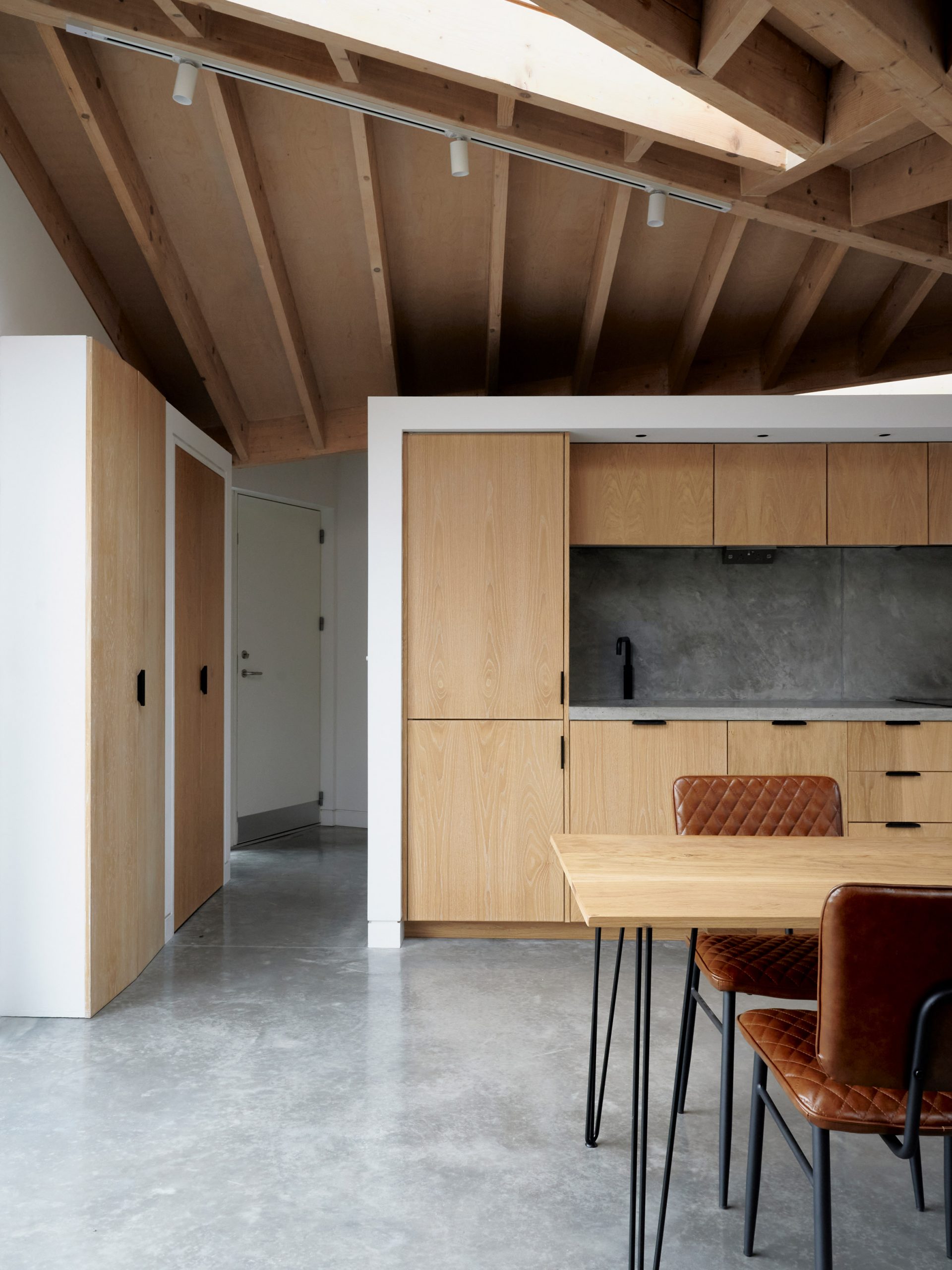 A kitchen with an exposed timber roof