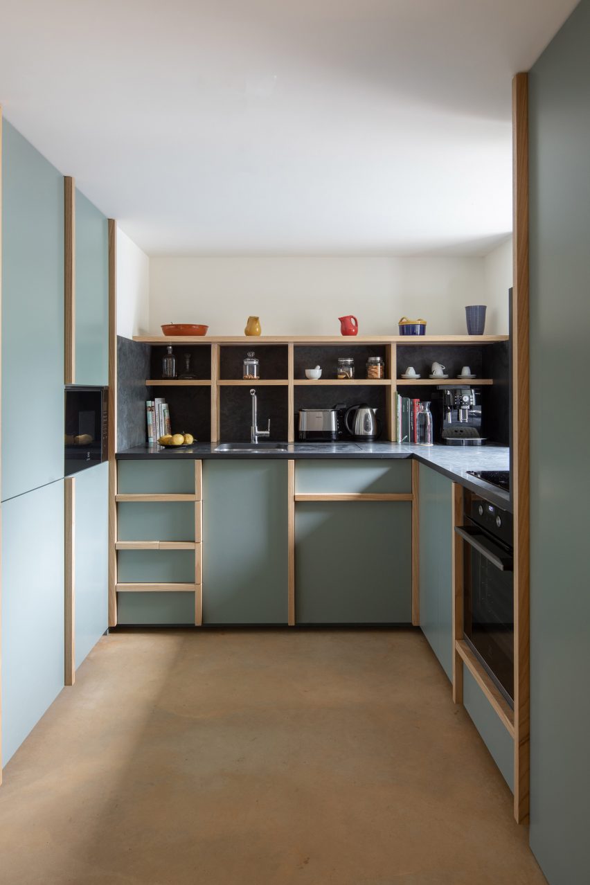 The kitchen is finished with a sage green by depA Architects