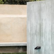A water fountain is built within a concrete wall