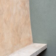 Ochre hued concrete is combined with sage green
