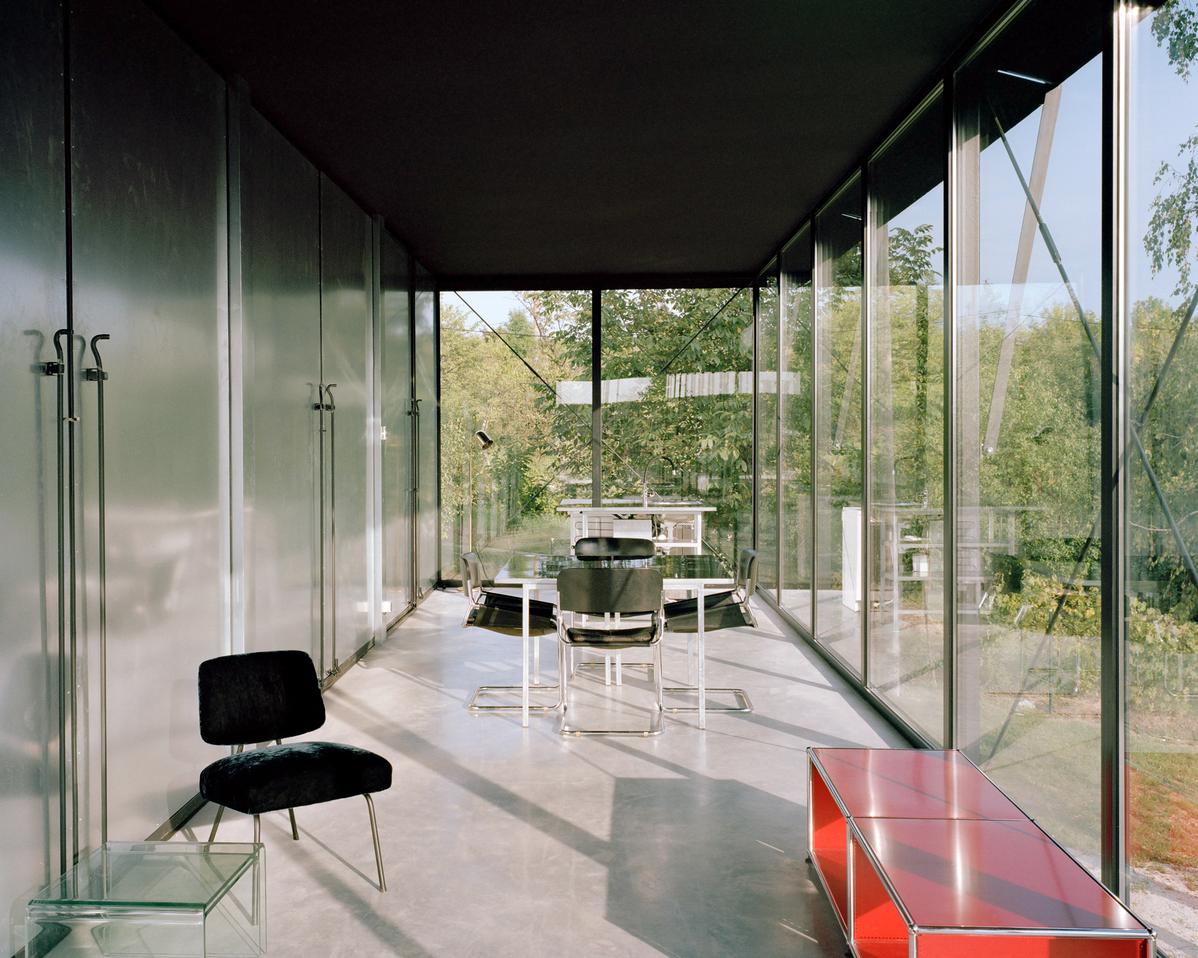 A living room with floor-to-ceiling glass windows