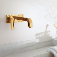 A gold wall-mounted tap