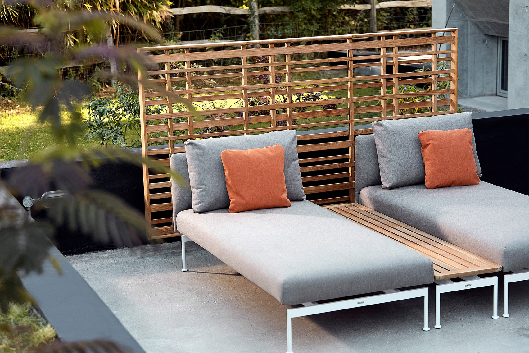 Layout lounge chairs on a patio by Barlow Tyrie