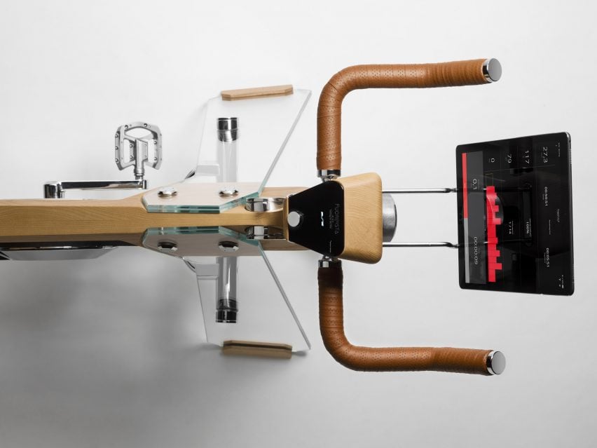 Aerial view of exercise bike by Elite and Adriano design with glass legs and wood frame