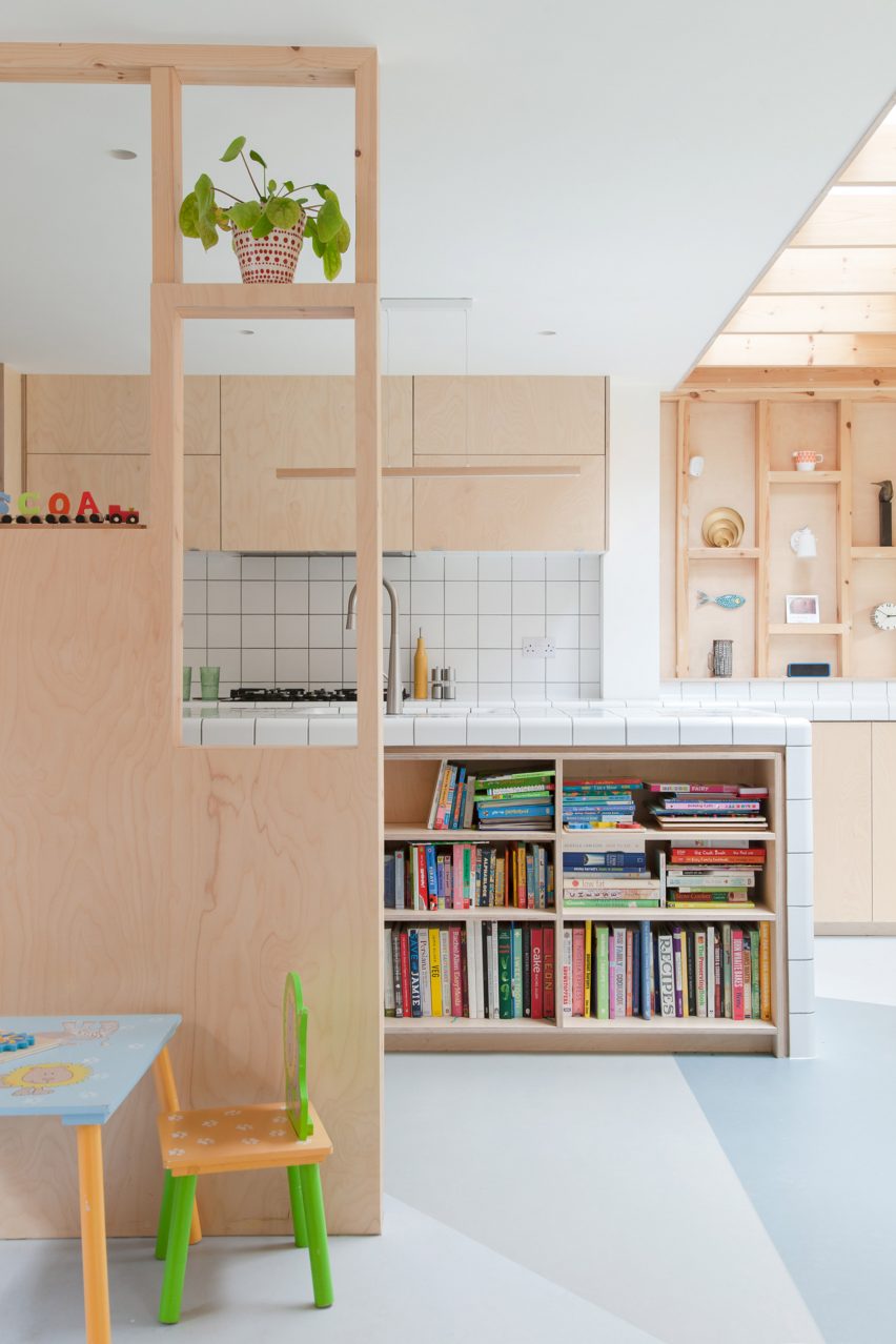 A kitchen with timber walls and cabinets