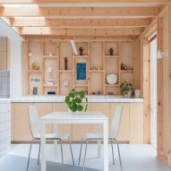 A kitchen with wooden walls and cabinets