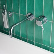 A sink with green tiles