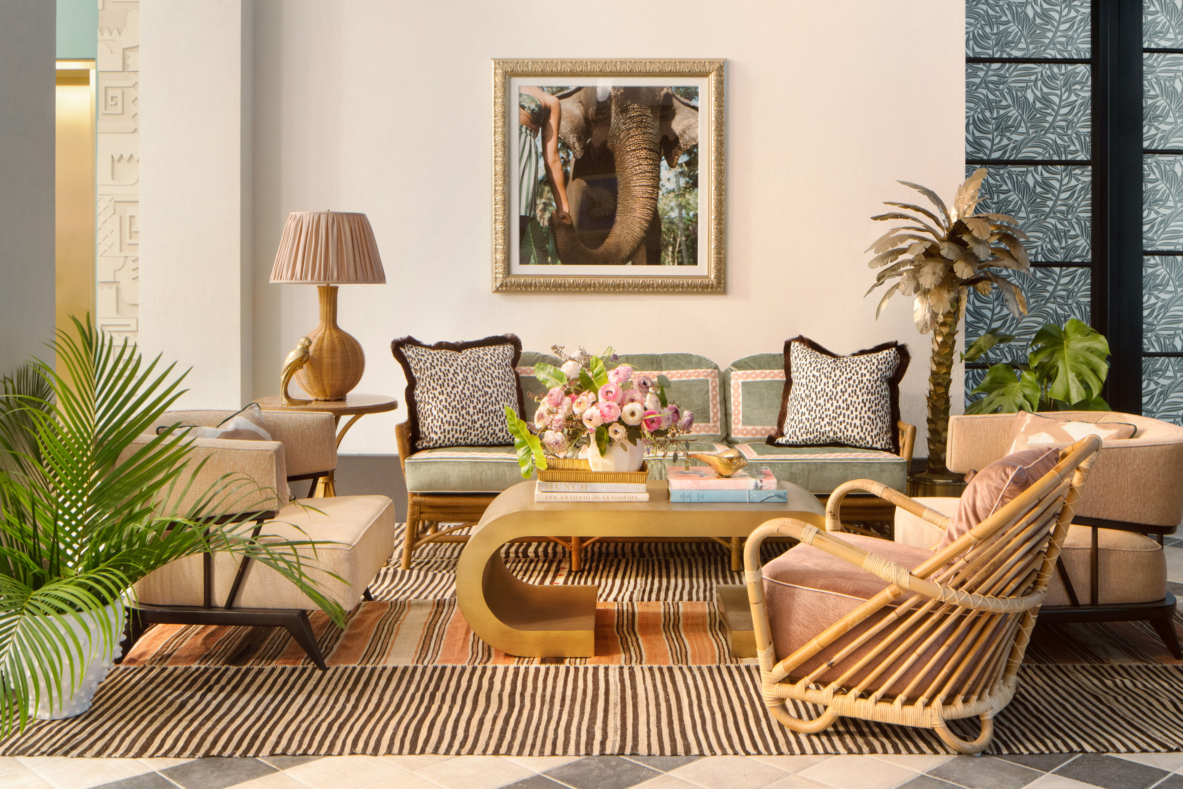 Lounge of Miami hotel with rattan furniture and leopard print pillows designed by Ken Fulk for Pharrell Williams and David Grutman