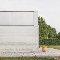 The pale brick facade of a Belgian bungalow