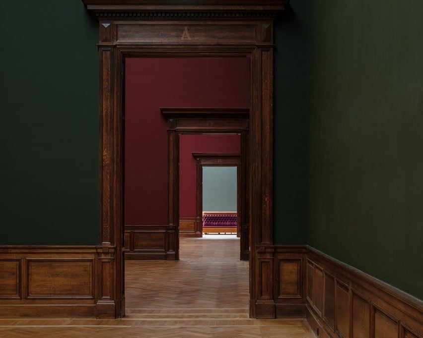 Dark green and red walls in restored 19th-century exhibition halls of Royal Museum of Fine Arts Antwerp