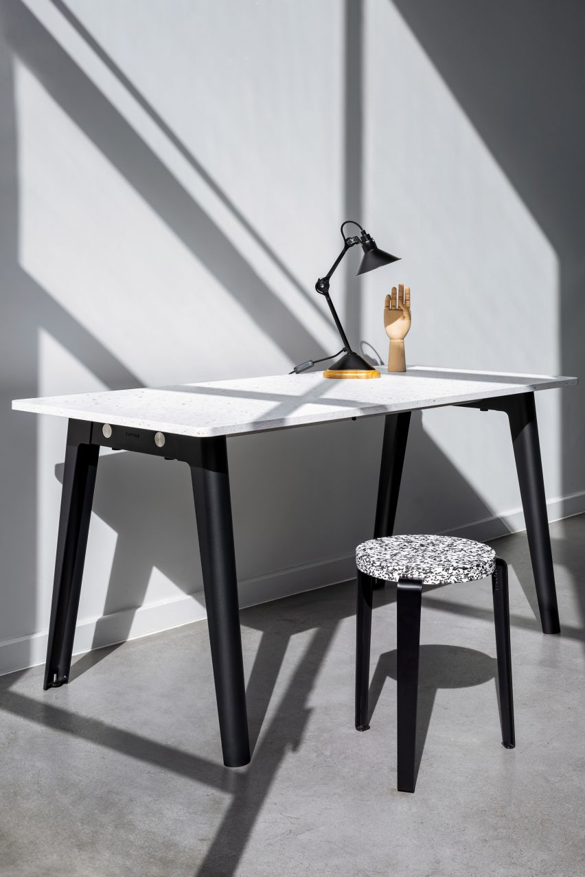 Desk by Tiptoe with black trestle-style legs and a recycled plastic top