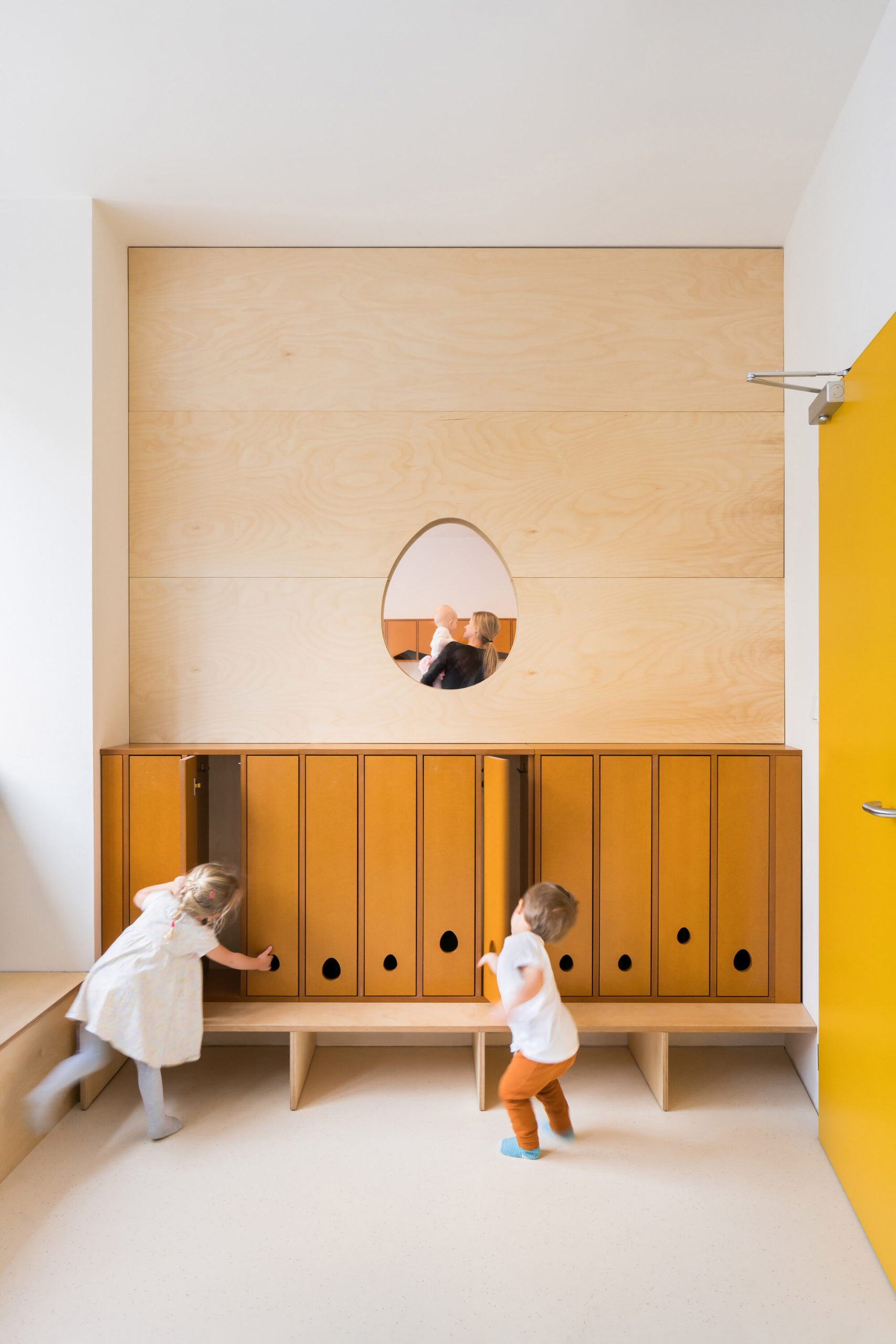  Mustard-coloured cape space with egg-shaped window in Malvína Day Nursery