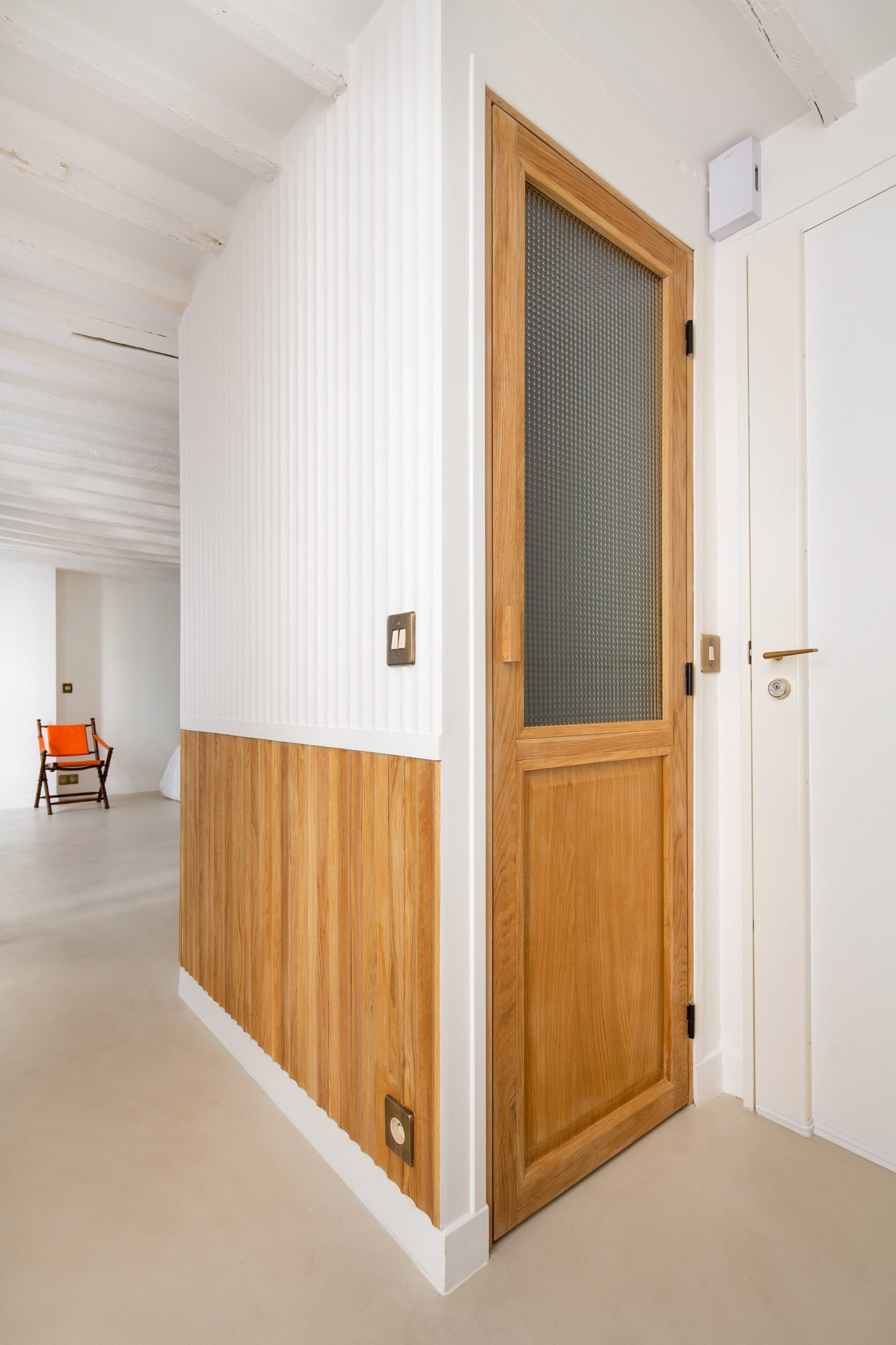 Doors have a stained wood and frosted glass construction 