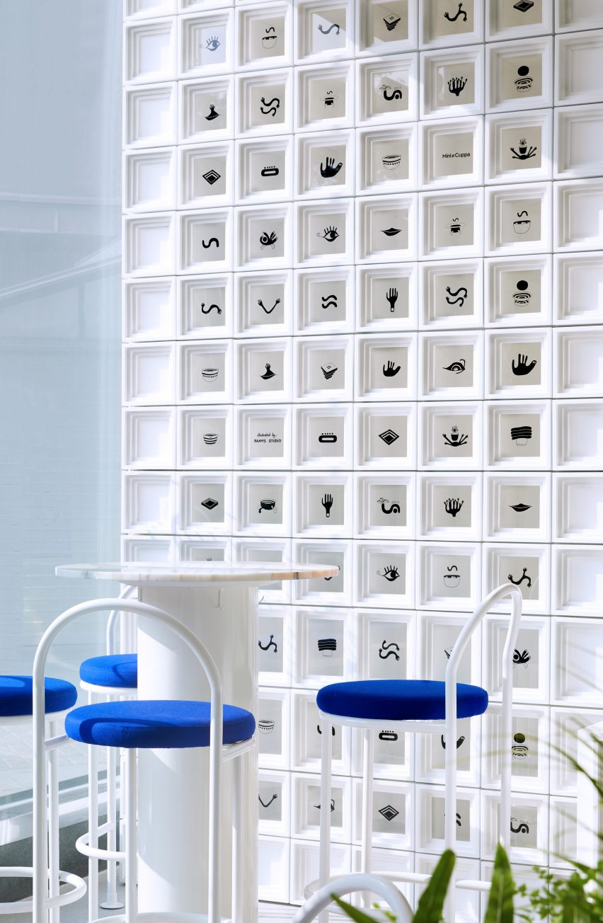 Wall of white cubes and small seating area in Shanghai's Mini Cuppa cafe