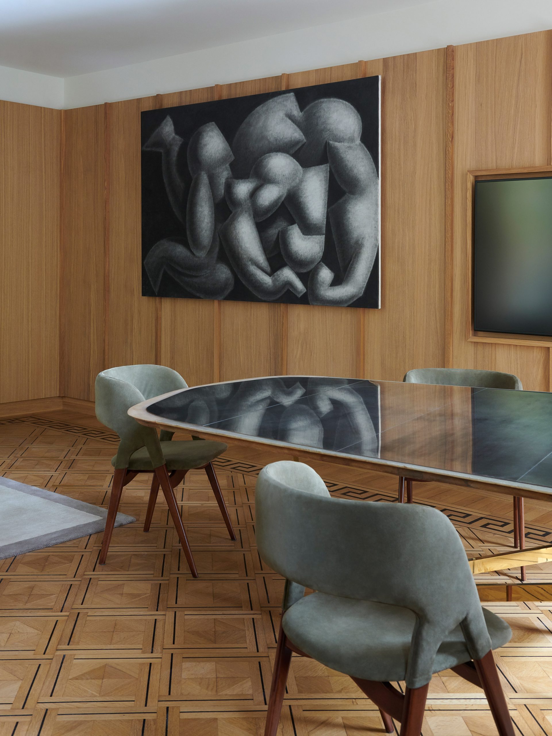Meeting room with abstract artwork and original oak floors in Amsterdam family office by Framework