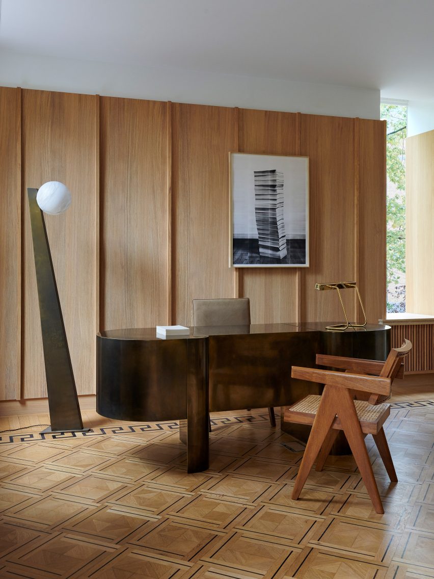 Brass desk and wood panelling in interior of Tesselschade family office