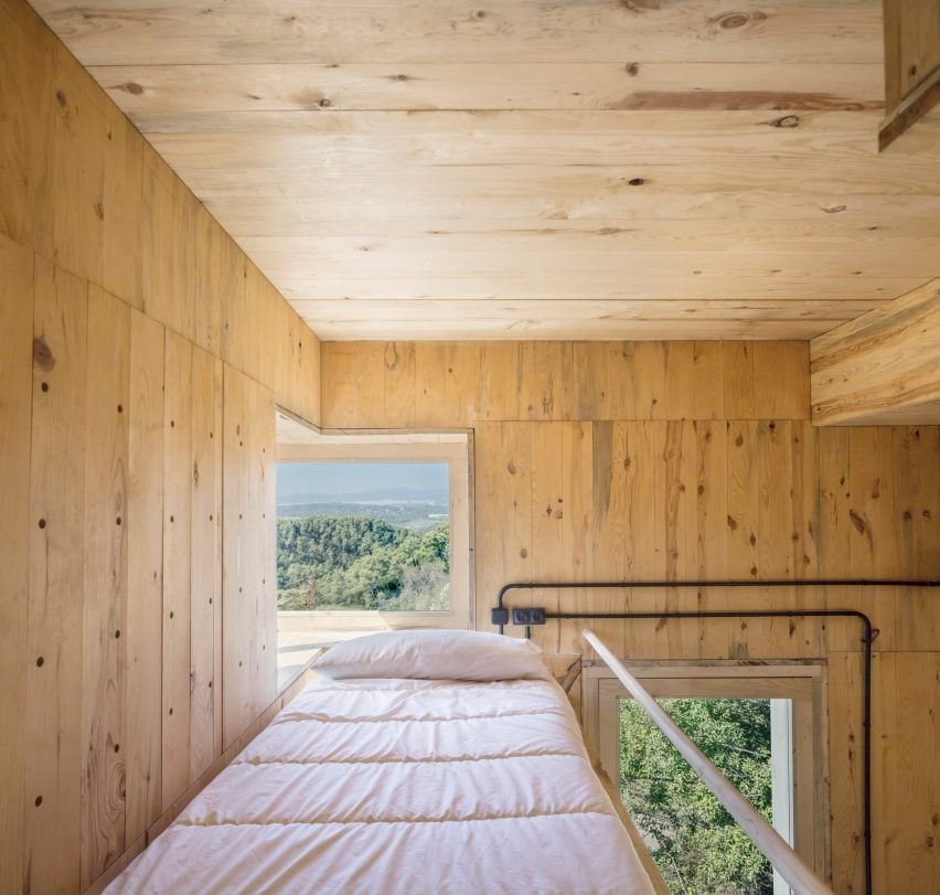 A platform bed inside a rural cabin