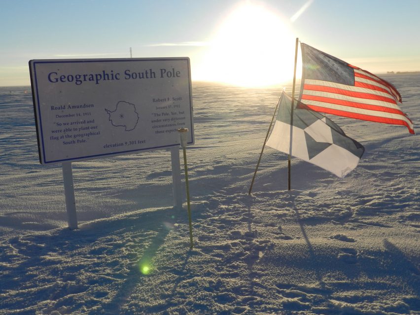 True South flag next to the US flag on the Geographic South Pole