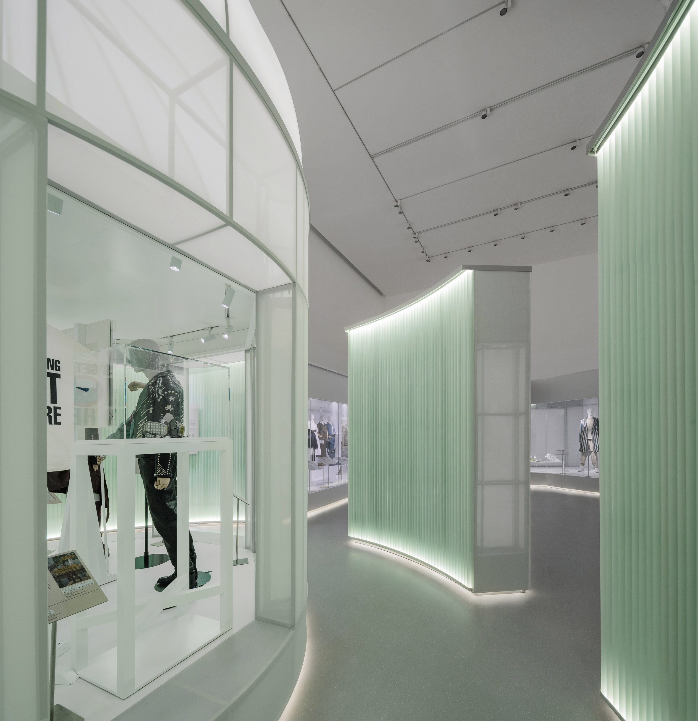 Acrylic pipes form a wall around the display cases by Studio 10