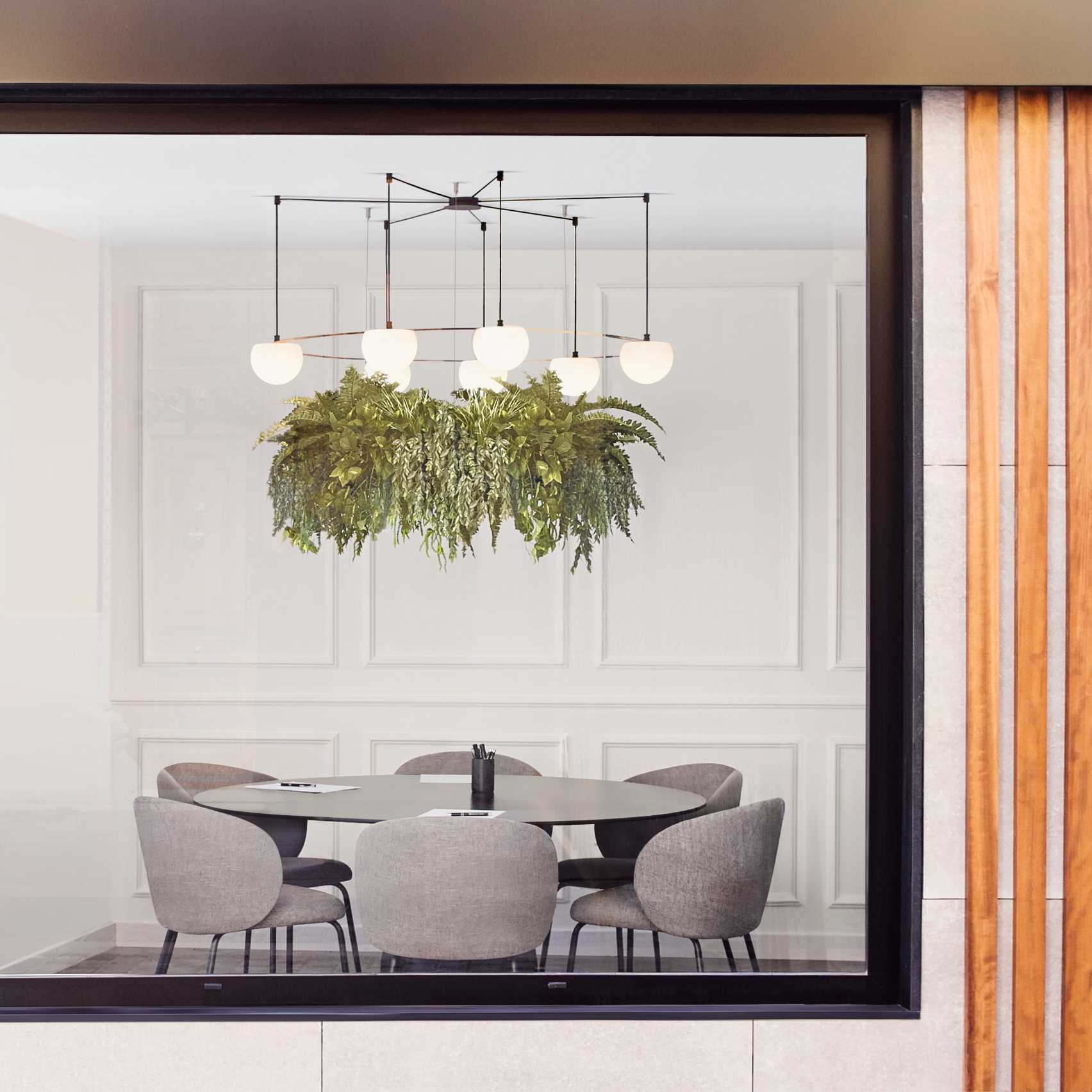 Circ pendant with planter hanging in an office meeting room
