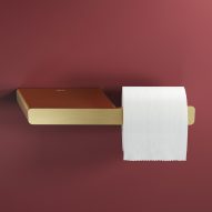 Single toilet roll holder with shelf in brushed gold finish by Geesa