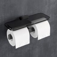 Double toilet roll holder with shelf holding a mobile phone