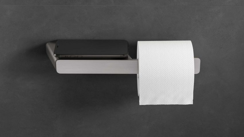 Mobile phone on the shelf of a toilet roll holder