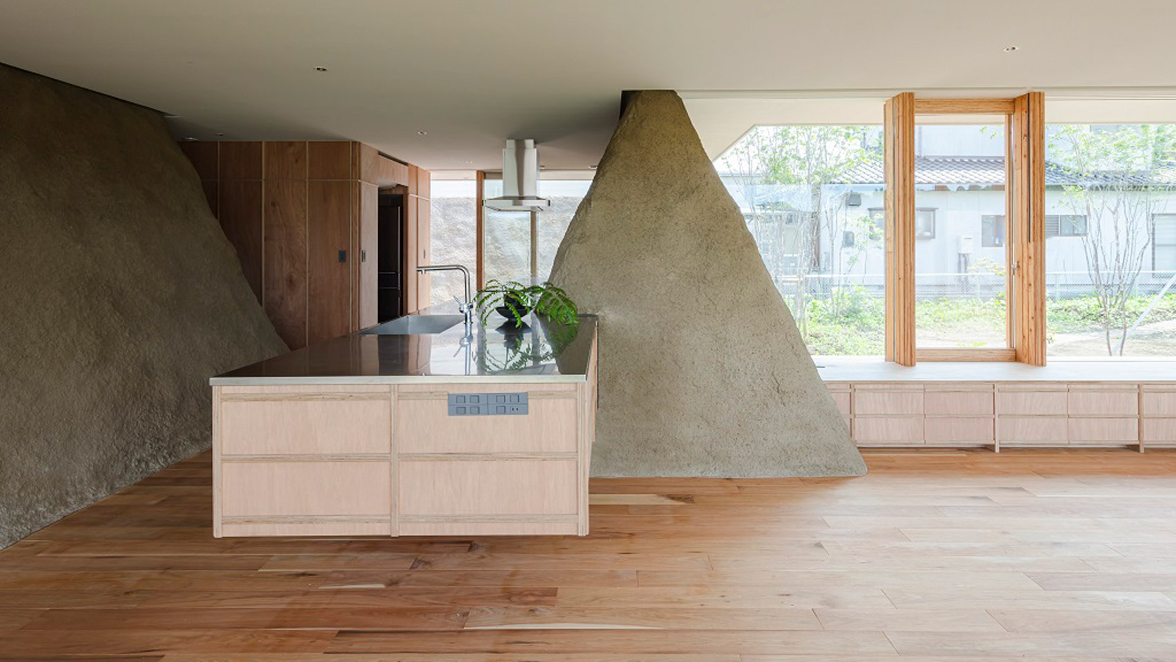 Mounds of surplus soil form walls in Japanese house by ADX - Vimarsana News