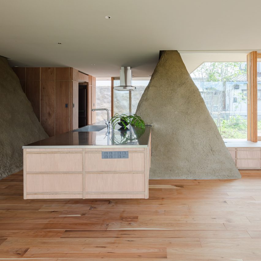 Mounds of surplus soil form walls in Japanese house by ADX