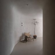 A plant and seating are placed against the walls