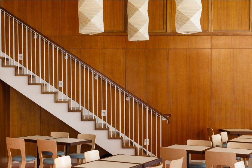 White staircase and wood-panelled walls in London restaurant by Macaulay Sinclair