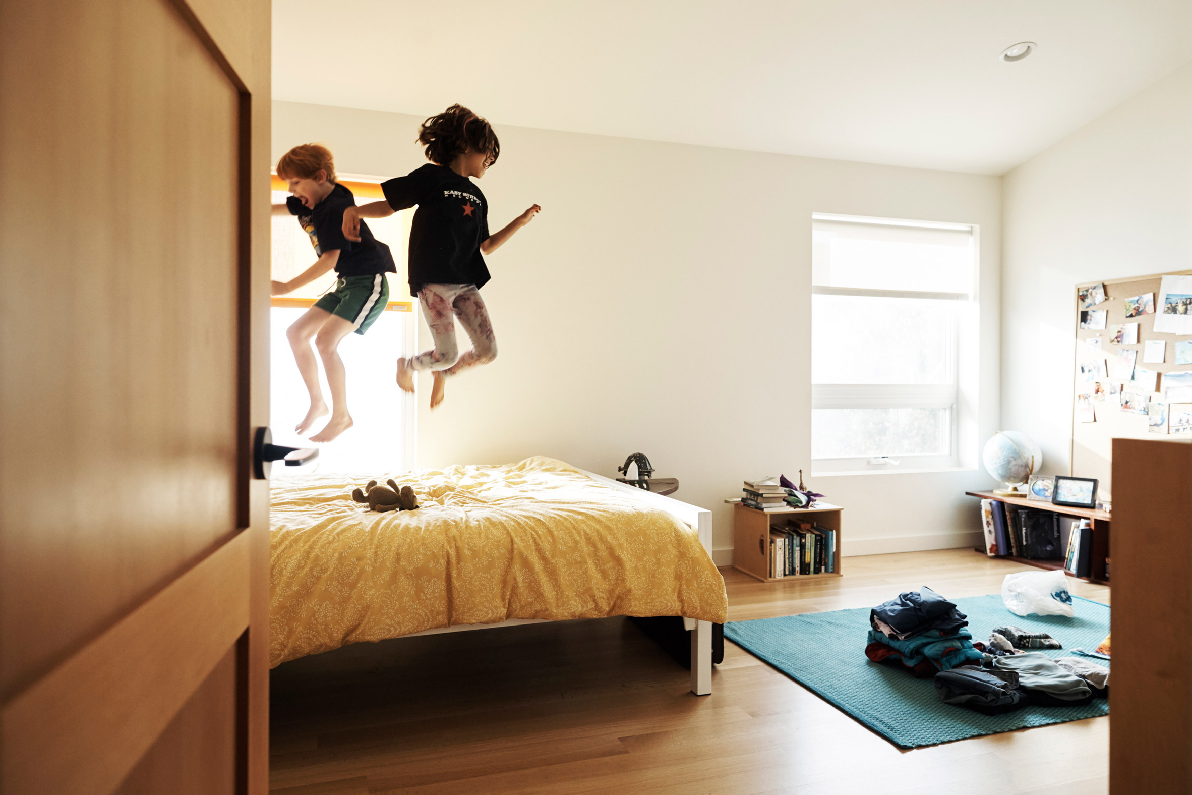 The couple's children enjoy jumping on their bed in Central Area Home