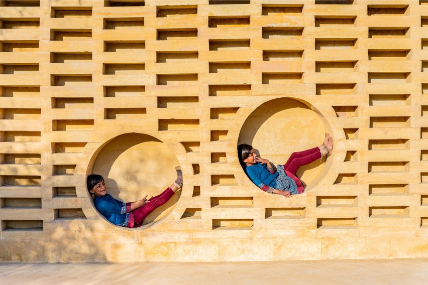 Children play within the brickwork