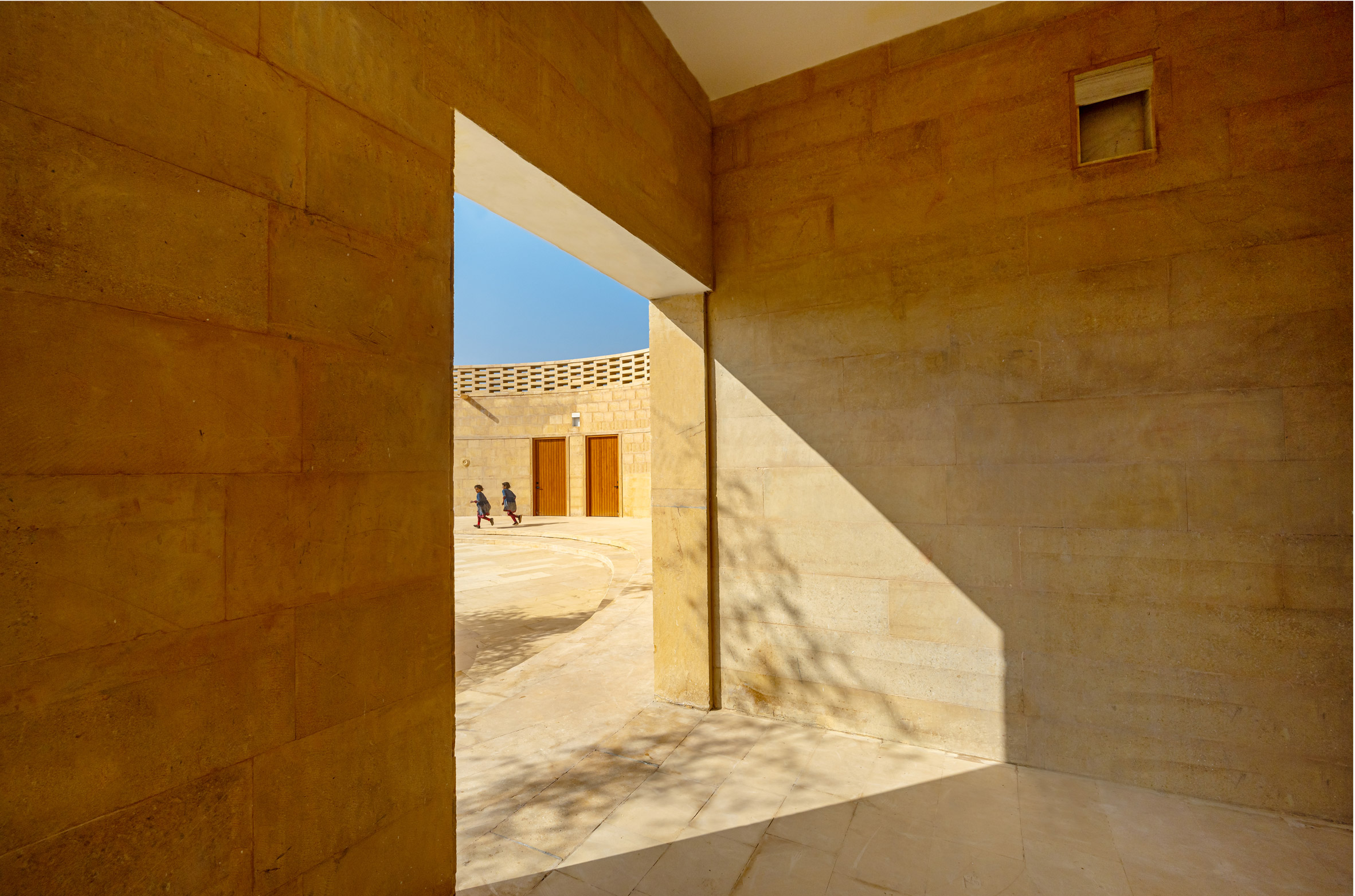 Sandstone was used across the walls and floors by Diana Kellogg Architects