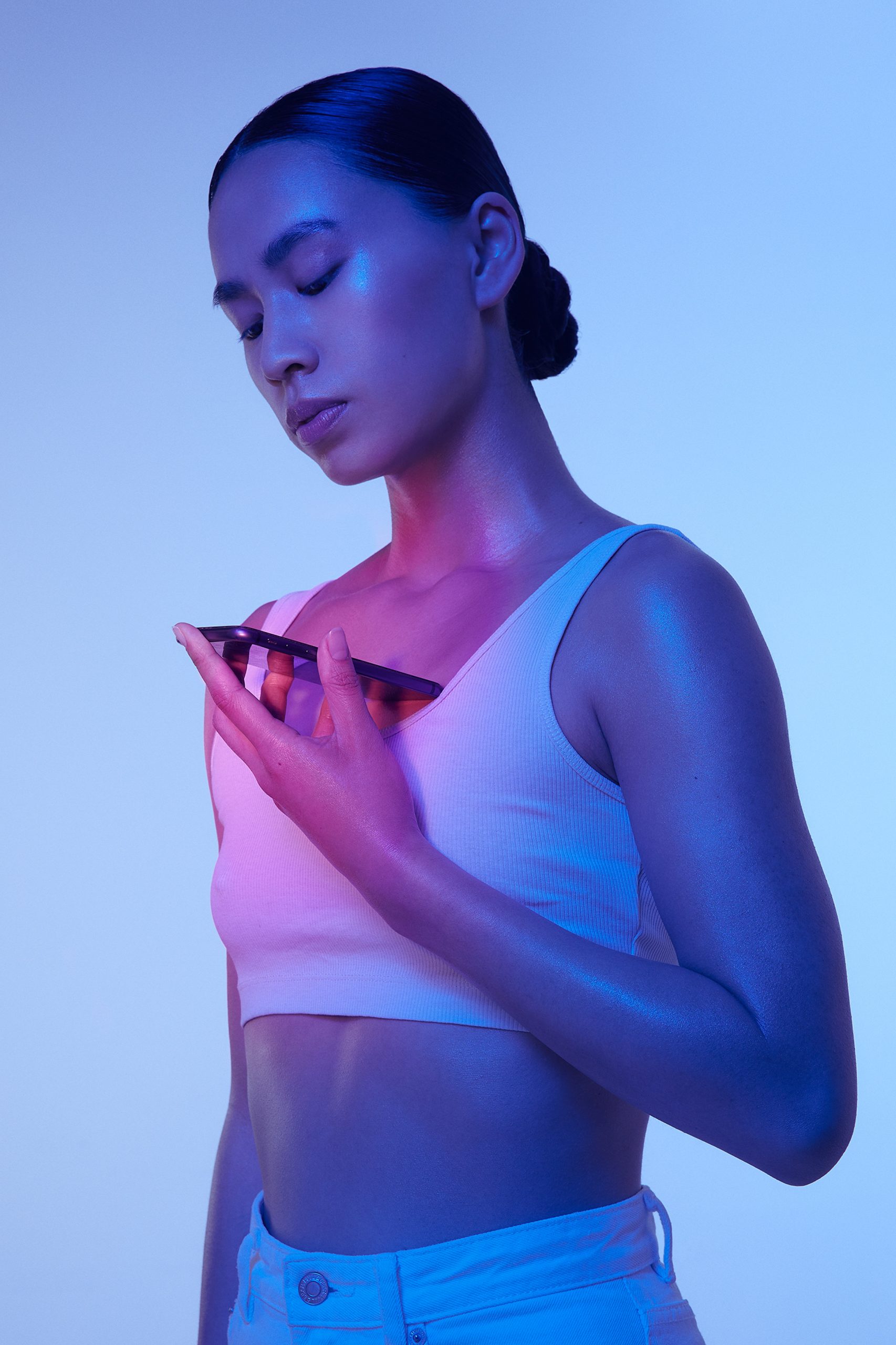 Woman holds glowing phone to her chest