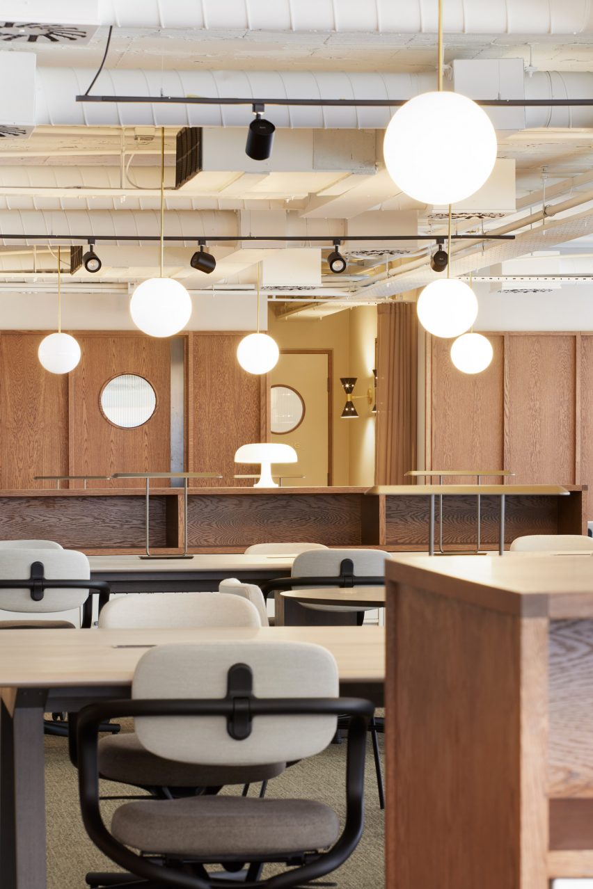 Spherical lights in wood-panelled office by dMFK Architects