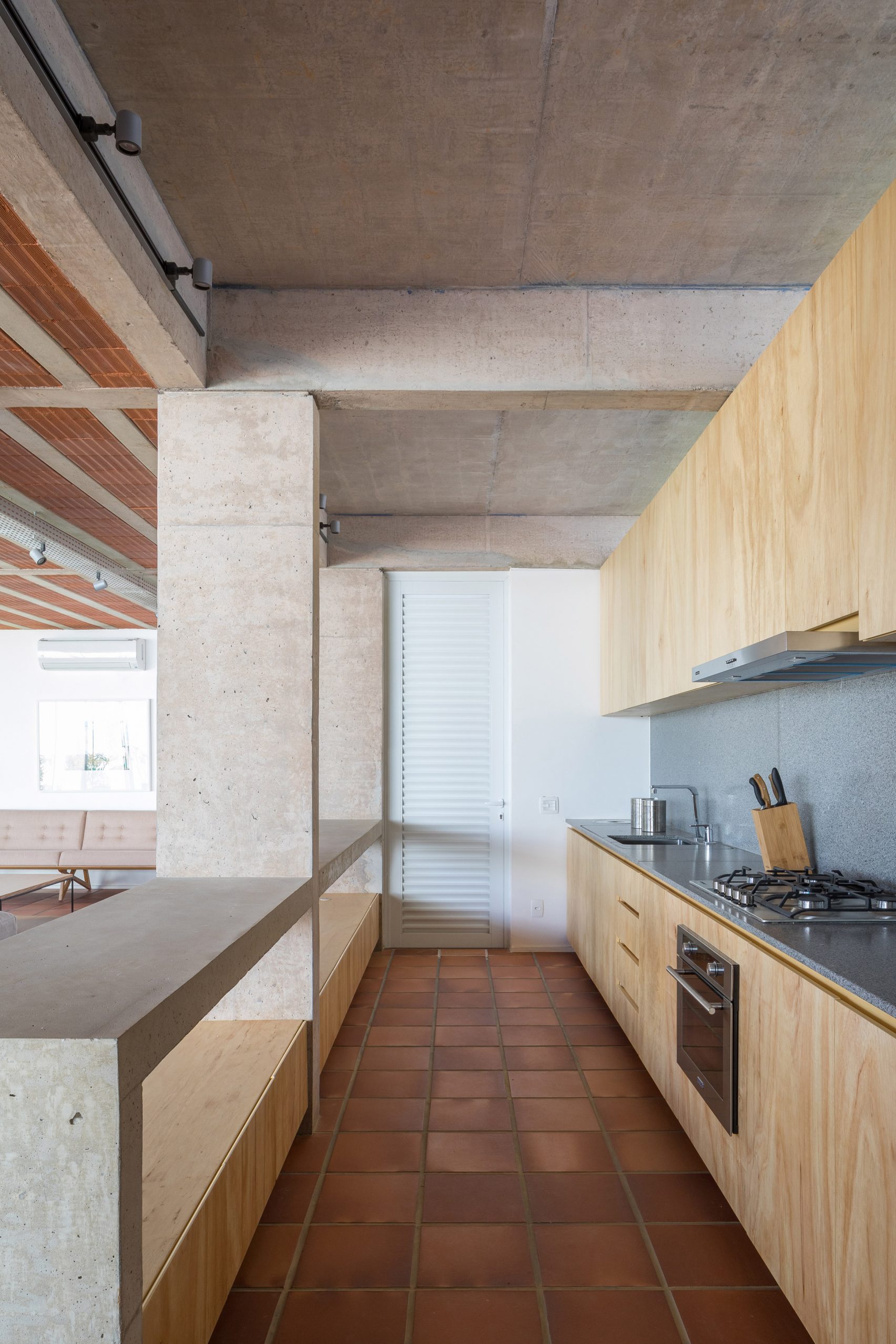 Clay tiles cover the floor of Portico House by Bloco Arquitetos