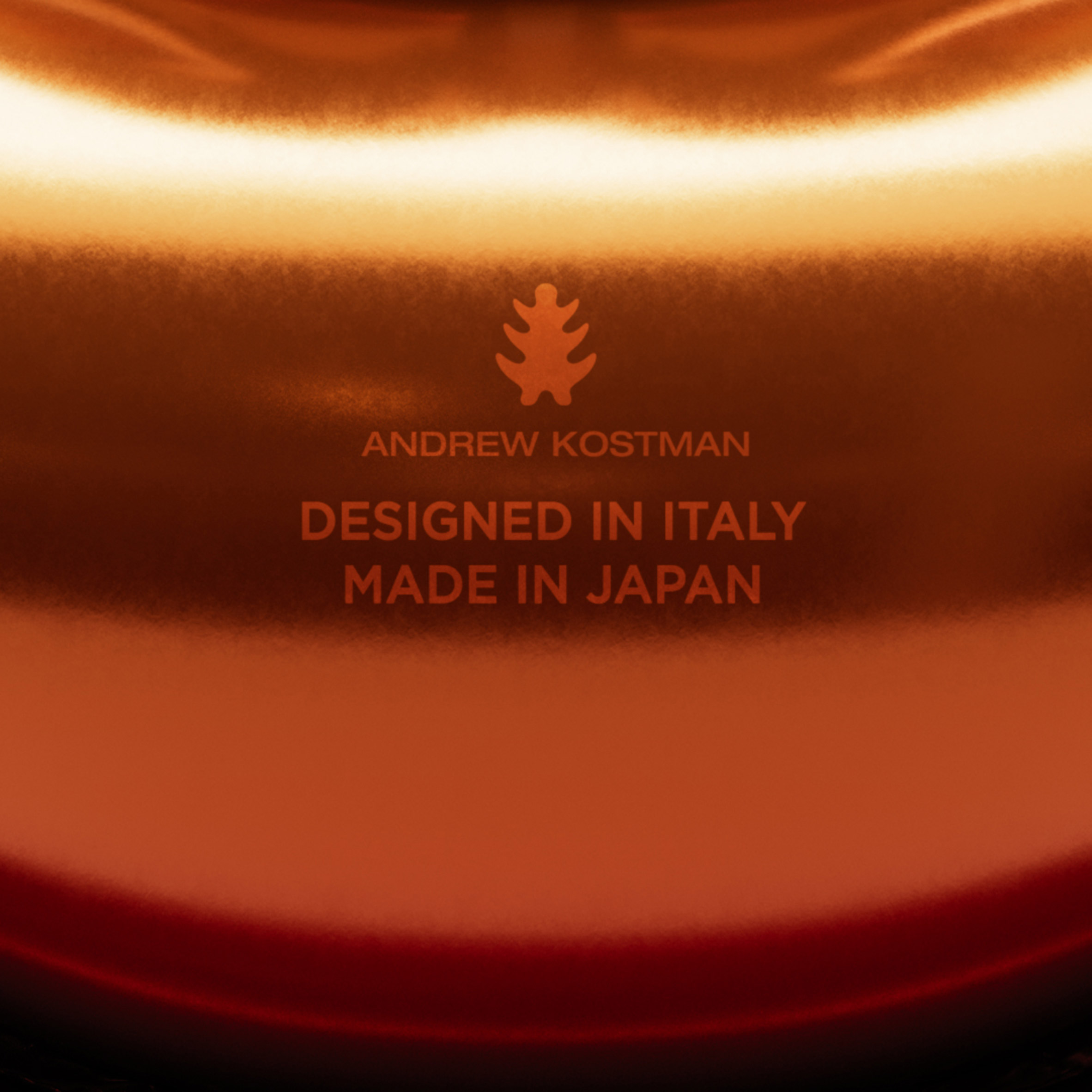 Close-up of Andrew Kostman logo that says designed in Italy and made in Japan