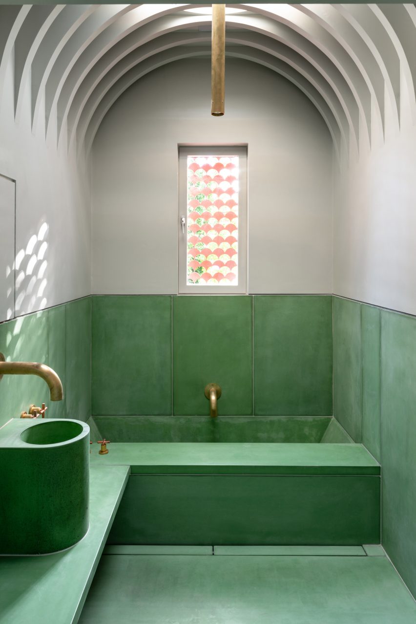 Kamar mandi beton berwarna hijau dan putih