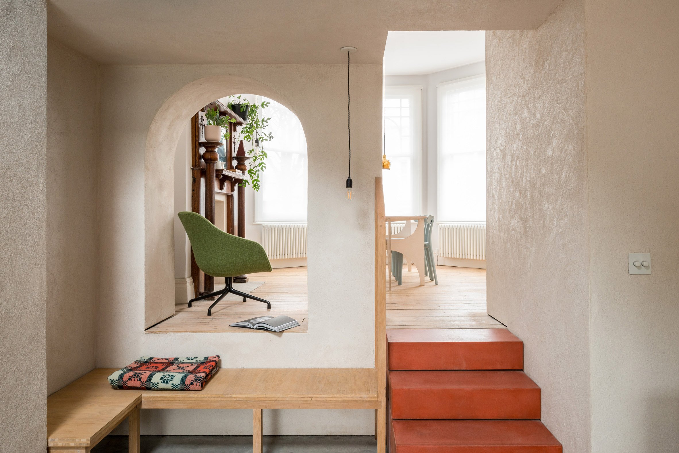 Arches frame the living space in House Recast