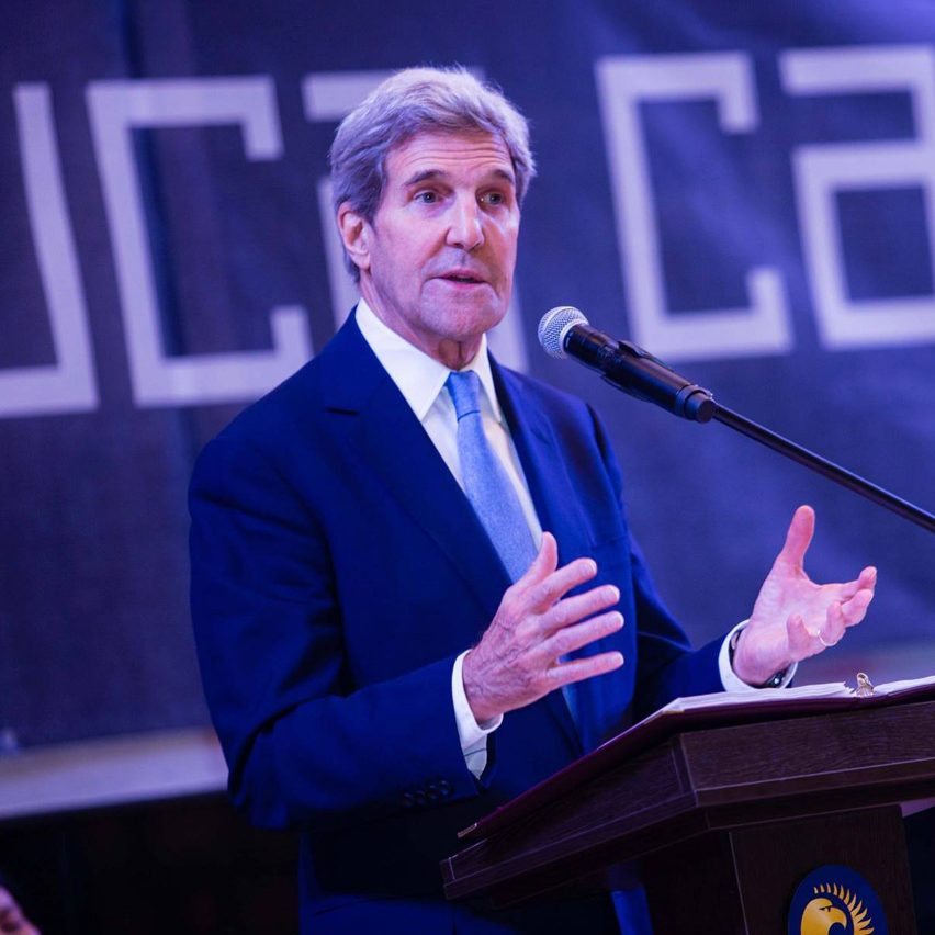 John Kerry speaking at a podium