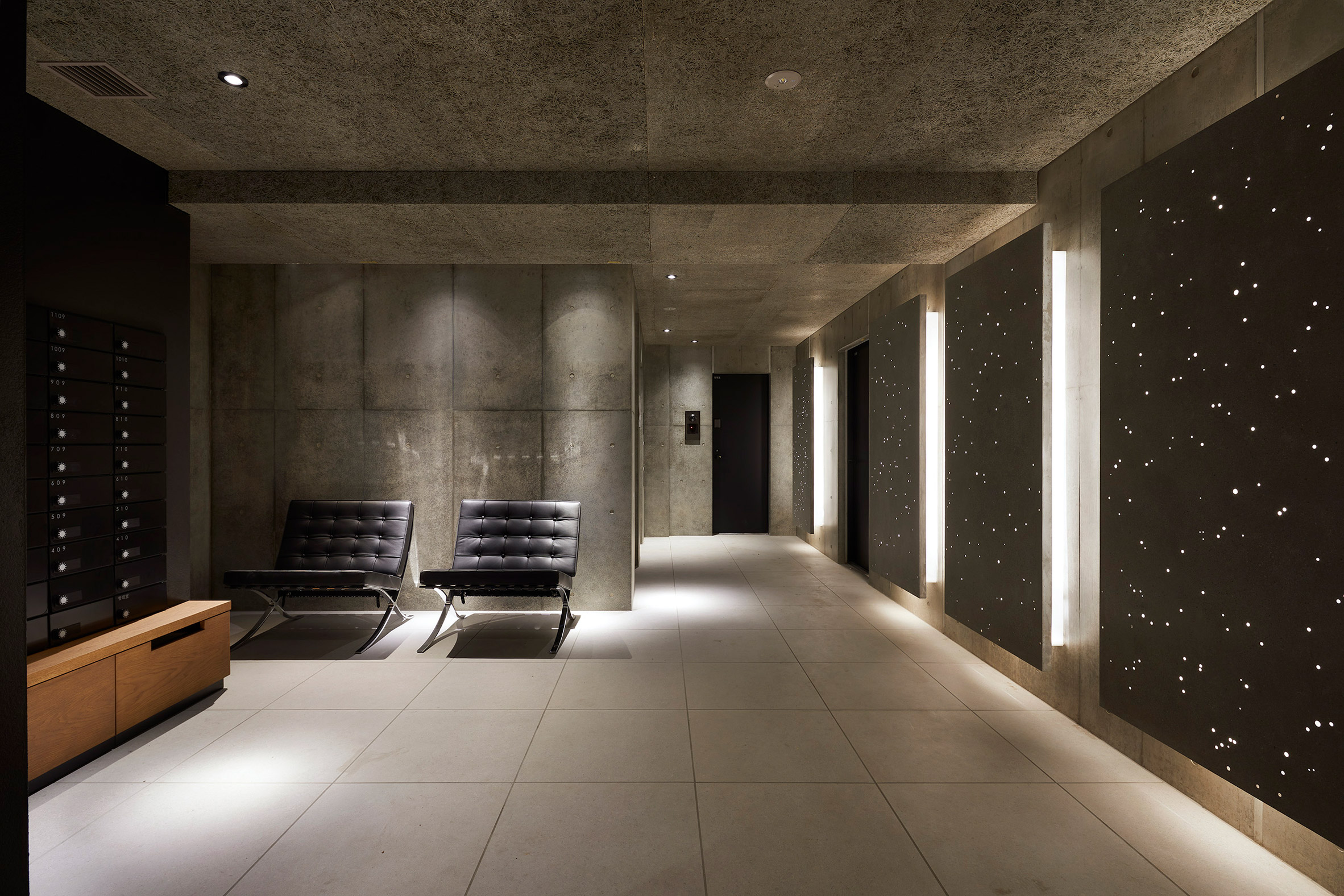 Concrete covers the walls of the interior of Kannai Blade Residence