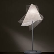 A slender table lamp with a sculptural PVC shade