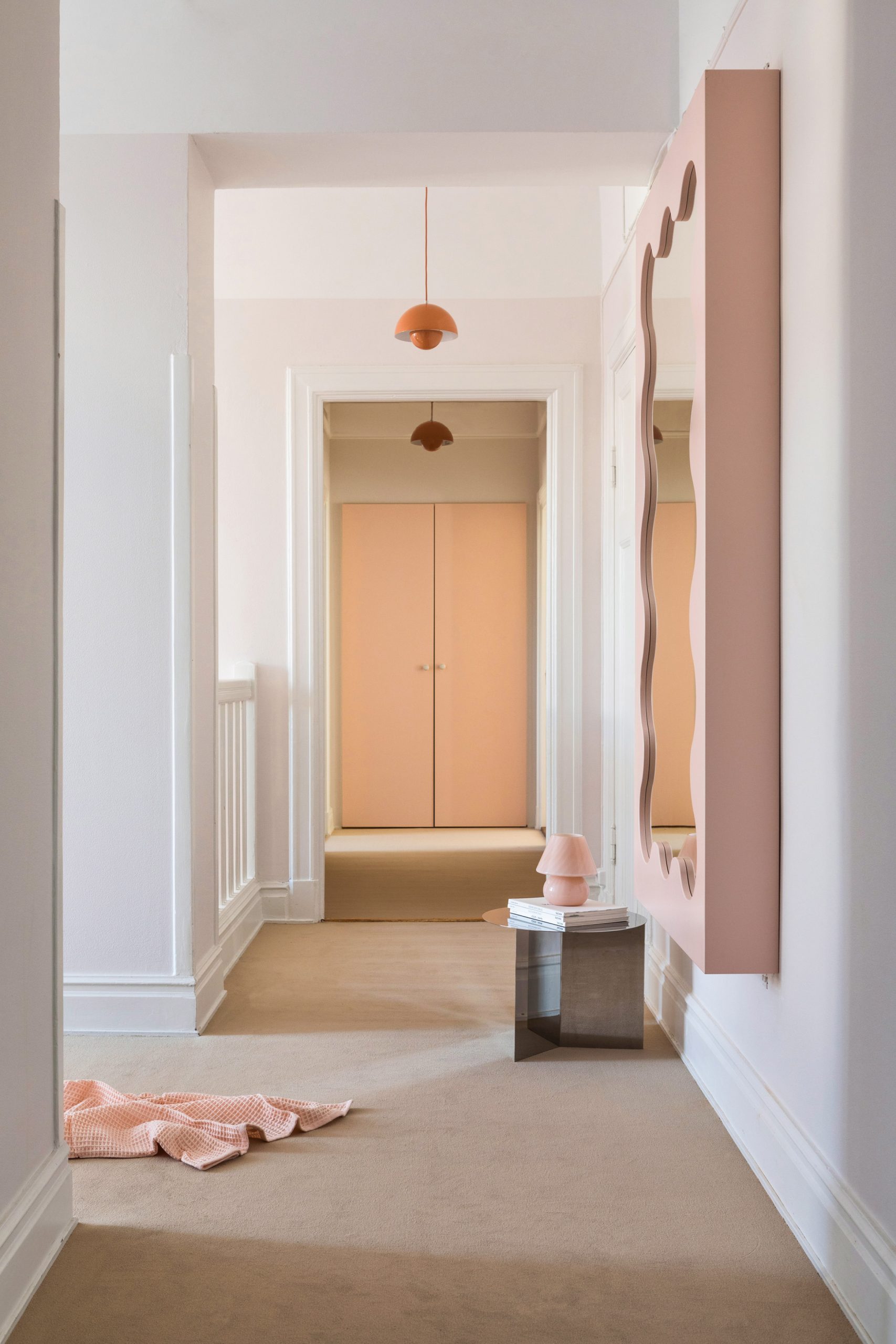 Pink mirror in hallway