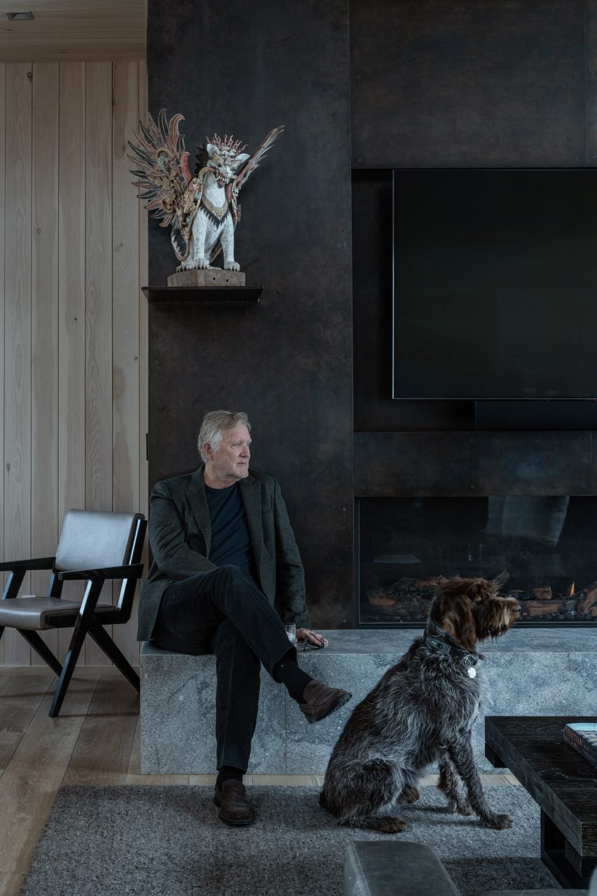 The architect by his blackened-steel fireplace