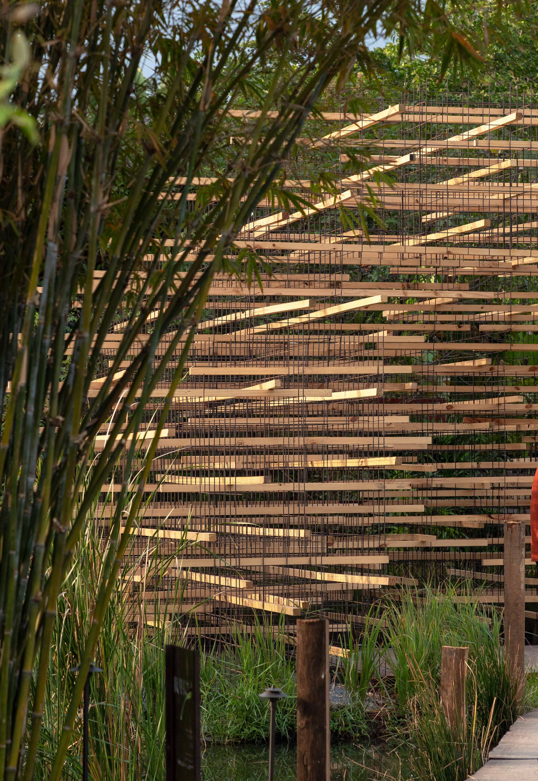 Wood was stacked and arranged in a lattice formation at the Straw Pavilion by MIA Design Studio