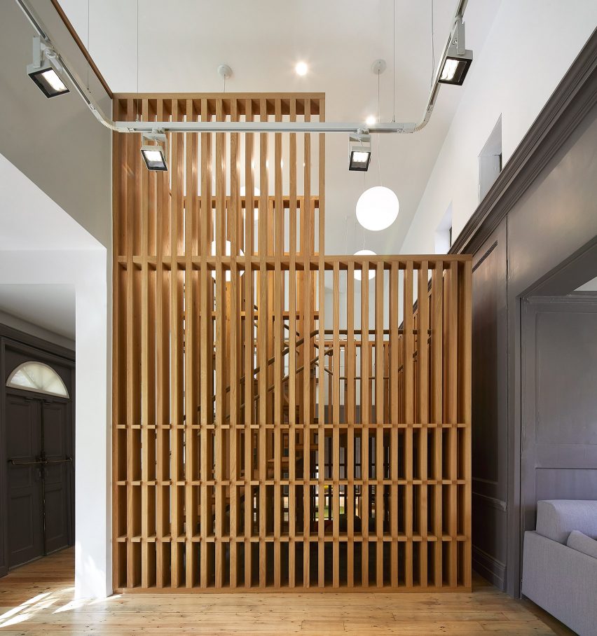 A staircase wrapped in a timber lattice