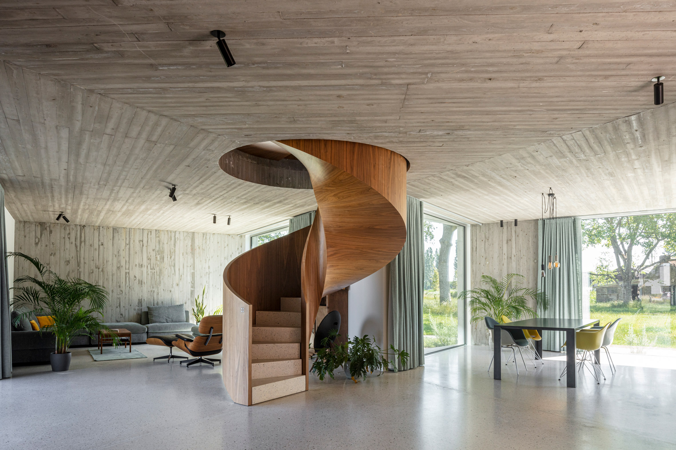 A wooden spiral staircase is located at the centre of House Dede